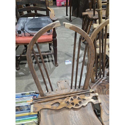 528 - A set of ten ash and elm wheelback Dining Chairs with shaped seats on turned supports and stretchers... 