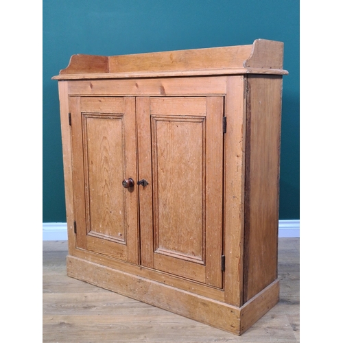 539 - A pine Cupboard with low raised back with a pair of panelled doors on plinth base, 3ft 3in H x 3ft 1... 