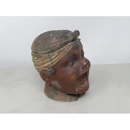 54 - A German bisque Tobacco Jar and Cover with open mouth figure having painted details, 4 1/2in (R1)