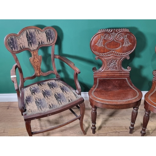 546 - A pair of Victorian mahogany Hall Chairs with carved backs and an Edwardian Elbow Chair with satinwo... 