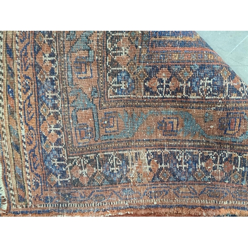 559 - A Persian style terra cotta ground woollen Rug, 6ft 5