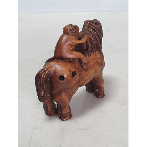 6 - Two carved wood Netsuke one in the form of a Monkey sat on a Horse, the other in the form of a Horse... 