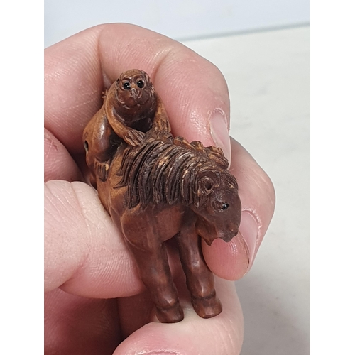 6 - Two carved wood Netsuke one in the form of a Monkey sat on a Horse, the other in the form of a Horse... 