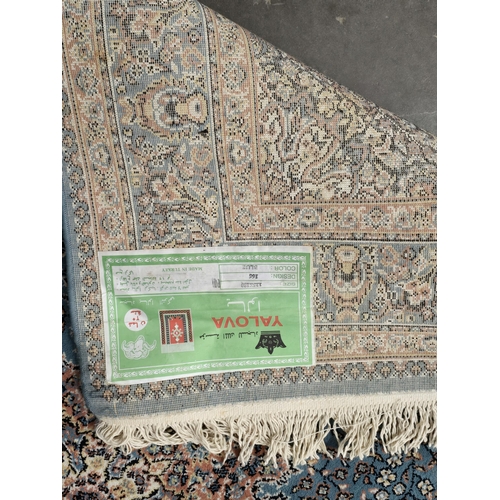 621 - A modern Turkish Rug with multi borders and floral decorations with central motif, 6ft 1