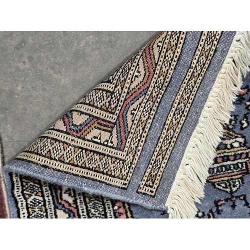 622 - A small Pakistan woollen Rug on a blue ground with two central floral motifs, 3ft x 2ft, and another... 