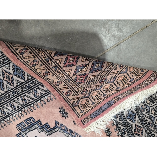 623 - A pink ground Rug with multi borders with large geometric medallion to centre, 5ft x 3ft 2