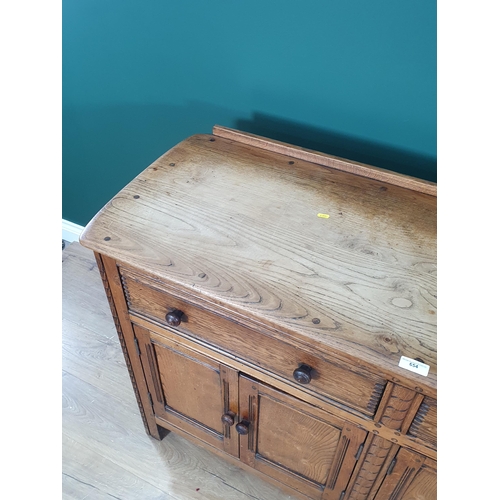 654 - An Ercol elm Dresser Base fitted two frieze drawers above four cupboard doors 4ft 9on W x 3ft H (R8)