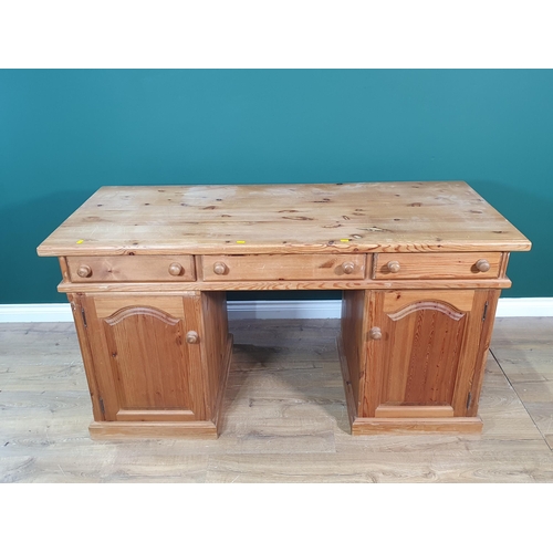 656 - A modern pine Desk fitted three drawers above pair of cupboard doors 5ft W x 2ft 8in H (R8)