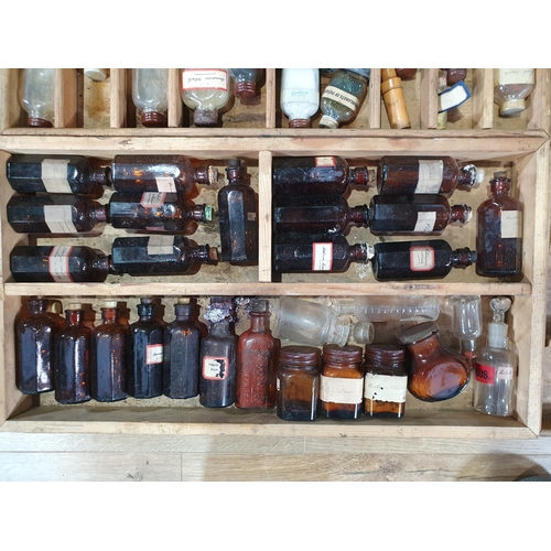 664 - An antique stained pine Chemist's Box containing fitted trays of bottles 2ft 1in W x 1ft 4in H (R8)