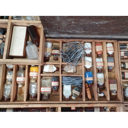 664 - An antique stained pine Chemist's Box containing fitted trays of bottles 2ft 1in W x 1ft 4in H (R8)