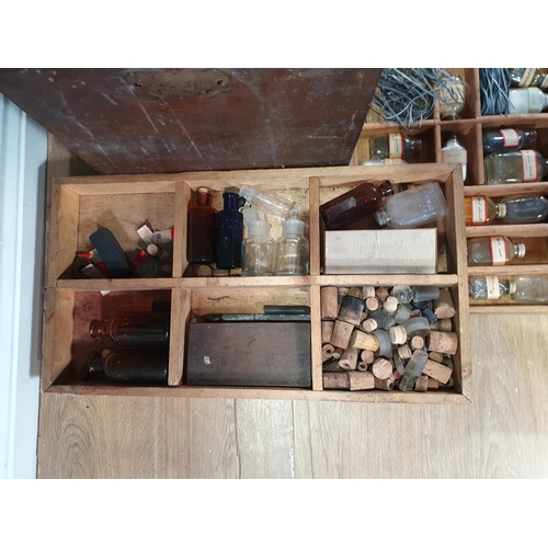 664 - An antique stained pine Chemist's Box containing fitted trays of bottles 2ft 1in W x 1ft 4in H (R8)