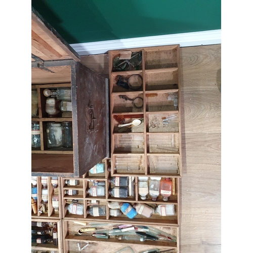 664 - An antique stained pine Chemist's Box containing fitted trays of bottles 2ft 1in W x 1ft 4in H (R8)