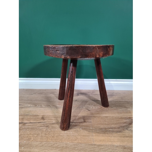 73 - An antique primitive Welsh Stool in elm and and ash with dished circular top on three splayed legs, ... 