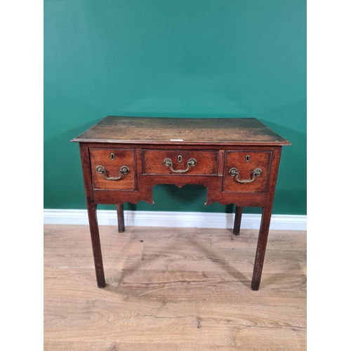 77 - An 18th Century oak Lowboy fitted three drawers around a shaped apron on chamfered square legs, 2ft ... 