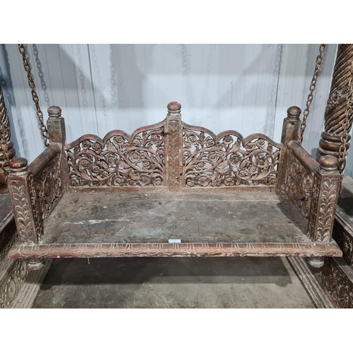 9 - A carved Indian hardwood Swing Seat, with A frame canopy with carved rosette panel decoration, raise... 