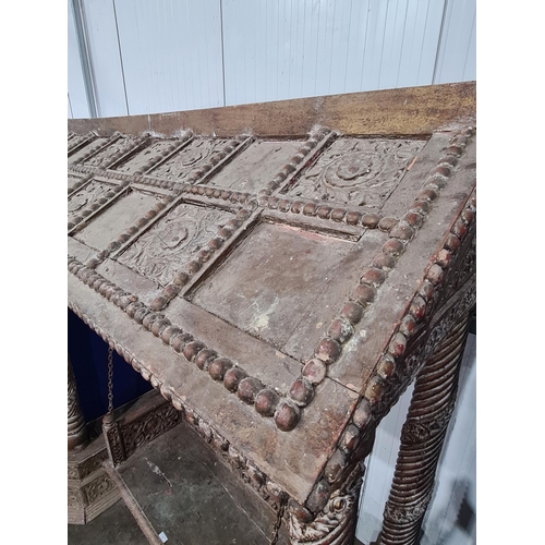 9 - A carved Indian hardwood Swing Seat, with A frame canopy with carved rosette panel decoration, raise... 