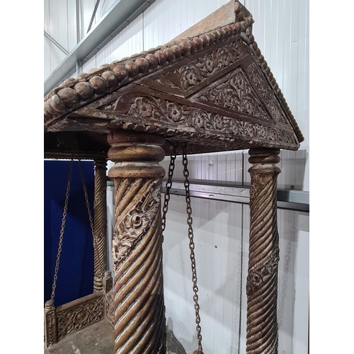 9 - A carved Indian hardwood Swing Seat, with A frame canopy with carved rosette panel decoration, raise... 