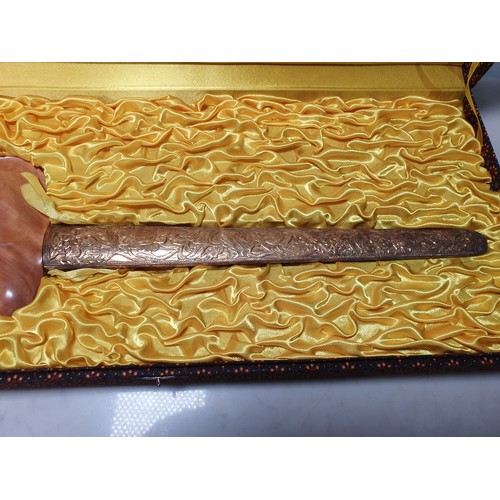 99 - An Indonesian Ceremonial Kris with dragon and striated blade, the grip with diamante set pommel, the... 