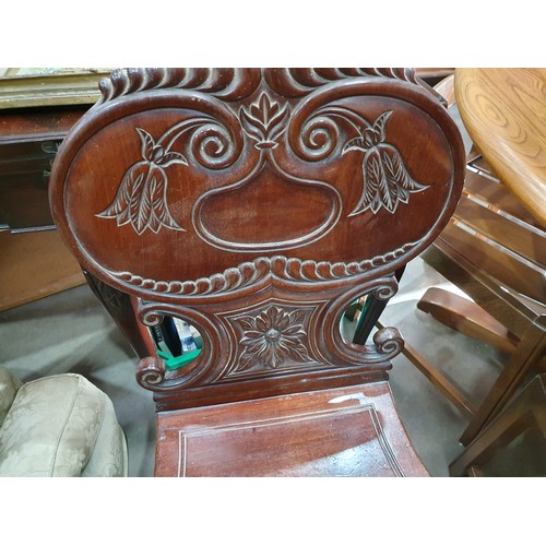 546 - A pair of Victorian mahogany Hall Chairs with carved backs and an Edwardian Elbow Chair with satinwo... 