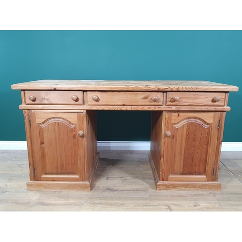 490 - A modern pine Desk fitted three drawers above pair of cupboard doors 5ft W x 2ft 8in H (R2).