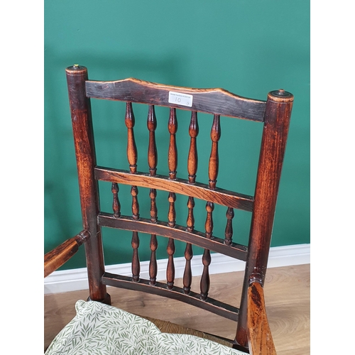 10 - An early 19th Century spindle back Elbow Chair and Single Chair with rush seats on turned front legs... 