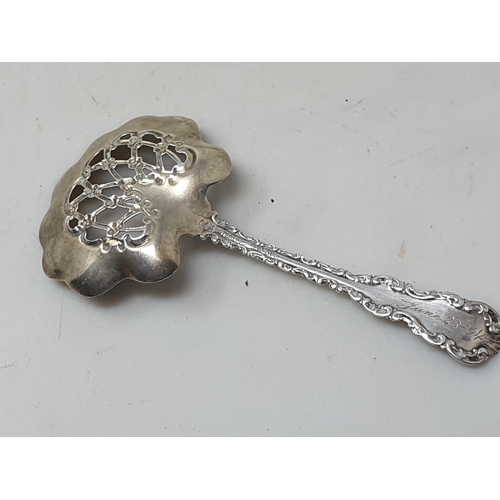 130 - A Russian style Dessert Spoon fiddle and shell pattern, a similar Teaspoon, plus sterling Sifting Sp... 