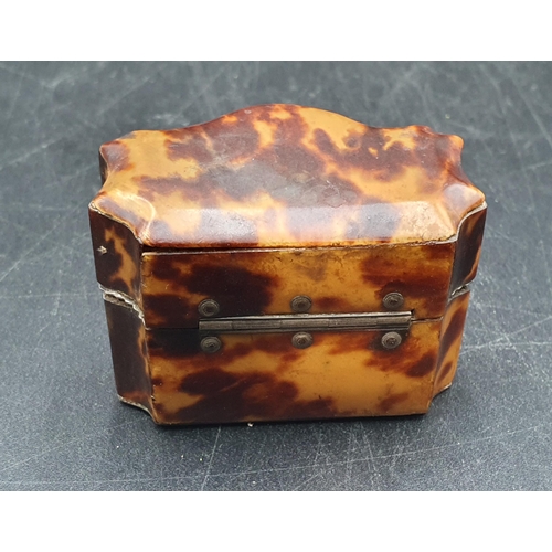 143 - A 19th Century tortoiseshell small Box with serpentine front, containing two small white metal lidde... 