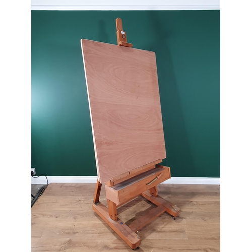 24 - A large beech Artist's Easel by Mabef, Itlay with adjustable tilt mechanism, over 6ft H, with two dr... 