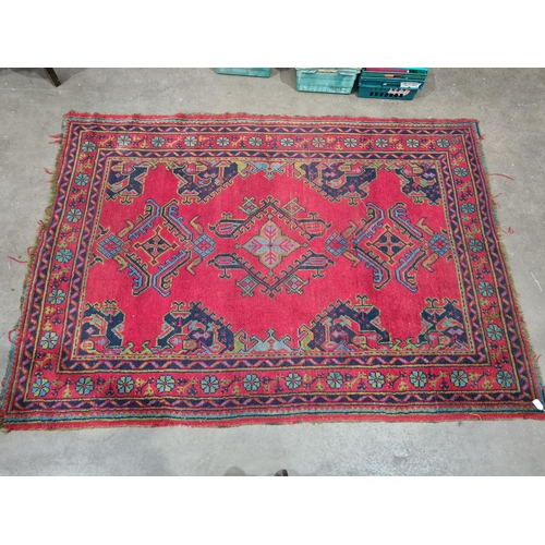 30 - A bordered Turkey Carpet with geometric design on a red ground, 6ft x 8ft 6in