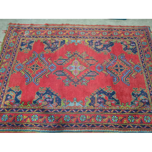 30 - A bordered Turkey Carpet with geometric design on a red ground, 6ft x 8ft 6in