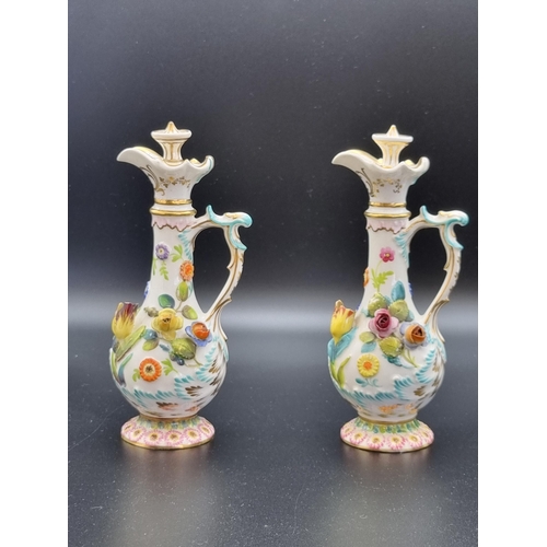 314 - A pair of Coalport Flasks with stoppers, scroll handles with floral encrusted decoration (damage and... 