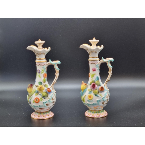 314 - A pair of Coalport Flasks with stoppers, scroll handles with floral encrusted decoration (damage and... 