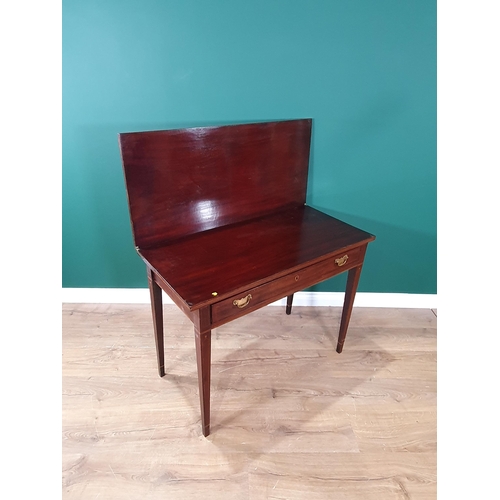 32 - A 19th century mahogany Tea Table with rectangular fold-over top above frieze drawer on square taper... 