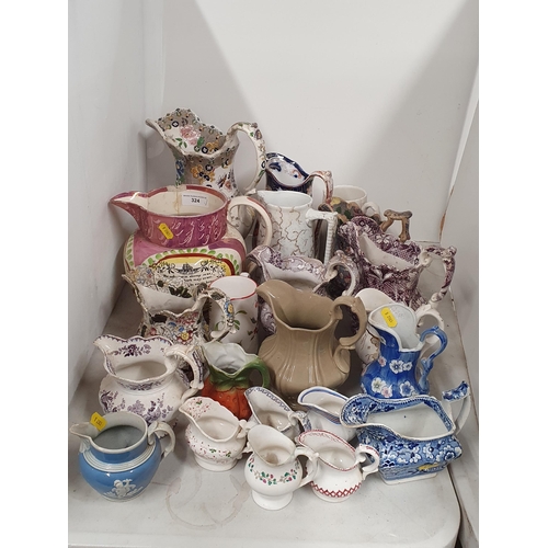 324 - A large collection of assorted ceramic Jugs to include a large pink lustre verse Jug, A/F, etc, (R4)