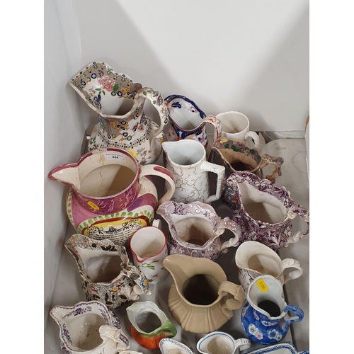 324 - A large collection of assorted ceramic Jugs to include a large pink lustre verse Jug, A/F, etc, (R4)