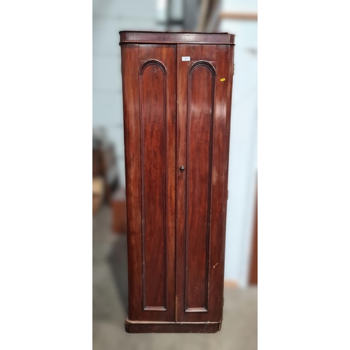 35 - A Victorian mahogany narrow Wardrobe fitted sliding trays and drawers enclosed by pair of panelled d... 