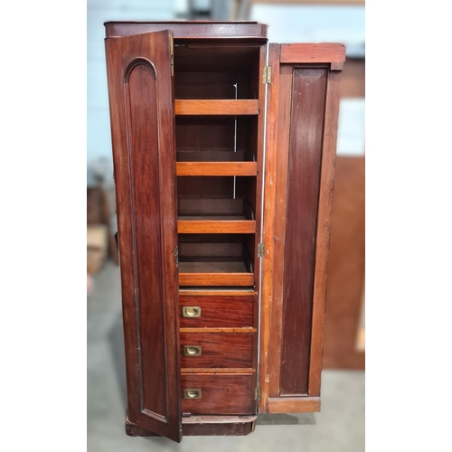 35 - A Victorian mahogany narrow Wardrobe fitted sliding trays and drawers enclosed by pair of panelled d... 