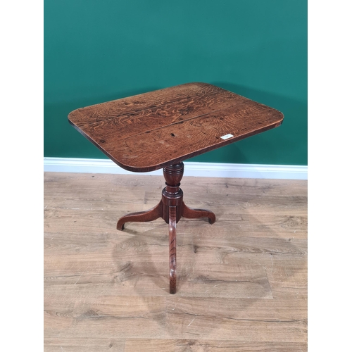 39 - An antique oak tilt top Table with rounded rectangular top on baluster turned column and tripod base... 