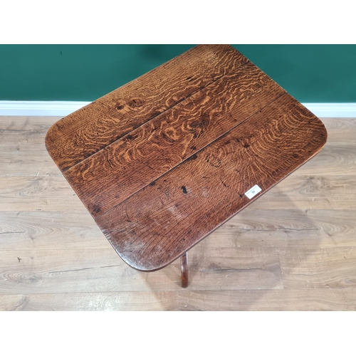 39 - An antique oak tilt top Table with rounded rectangular top on baluster turned column and tripod base... 