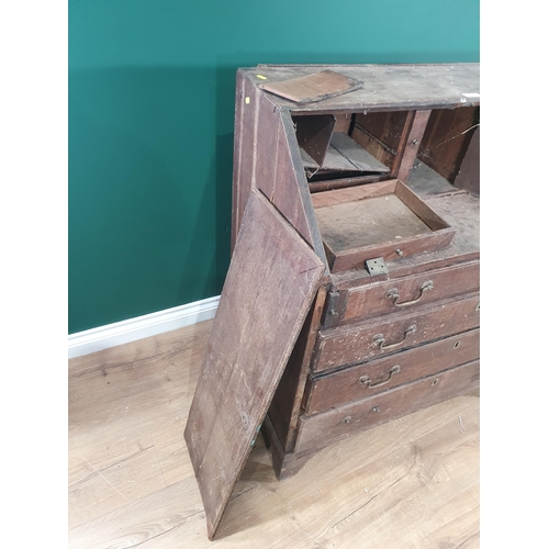 498 - An antique oak Bureau with fitted interior and fitted four long drawers, 3ft W in need of restoratio... 