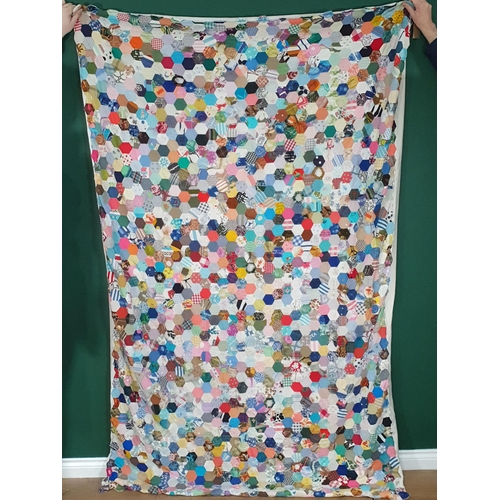 522 - A Patchwork Quilt/Blanket decorated with multi coloured hexagonal patches some with floral designs, ... 