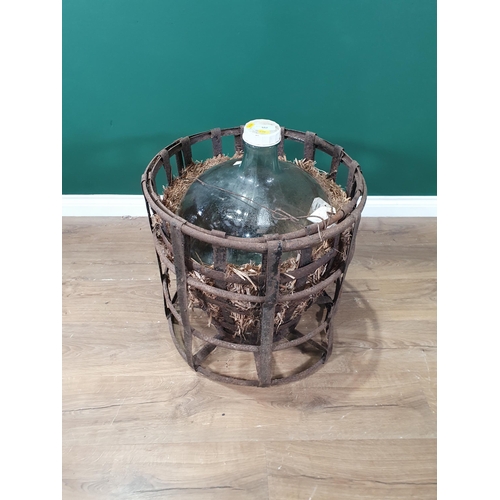 557 - A large glass Carboy in a metal cage (R5)