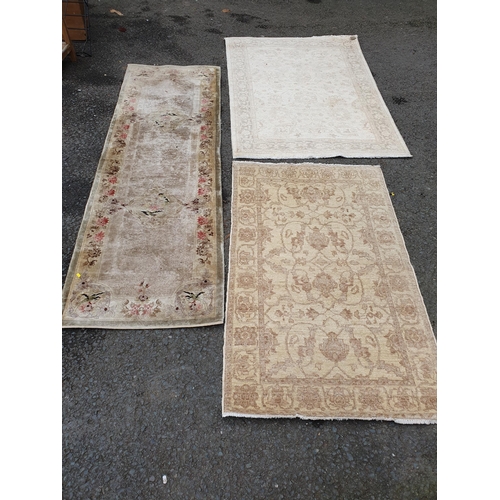 586 - Two beige coloured Rugs with floral designs, 5ft 9in x 4ft, and 5ft 2in x 3ft 1in, and a floral bord... 