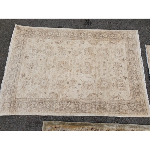 586 - Two beige coloured Rugs with floral designs, 5ft 9in x 4ft, and 5ft 2in x 3ft 1in, and a floral bord... 