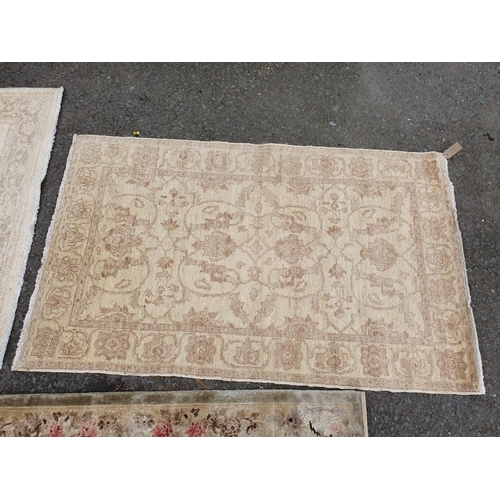 586 - Two beige coloured Rugs with floral designs, 5ft 9in x 4ft, and 5ft 2in x 3ft 1in, and a floral bord... 