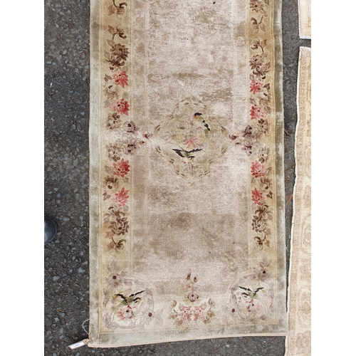 586 - Two beige coloured Rugs with floral designs, 5ft 9in x 4ft, and 5ft 2in x 3ft 1in, and a floral bord... 