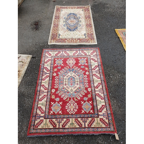 587 - A bordered Persian style Rug with central medallion on a red ground, 4ft 9in x 3ft 6in, and a border... 