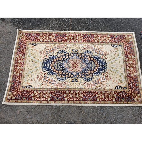 587 - A bordered Persian style Rug with central medallion on a red ground, 4ft 9in x 3ft 6in, and a border... 