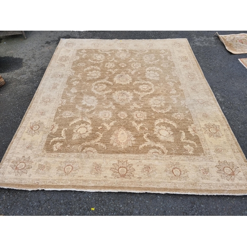 589 - Two large beige Rugs with floral designs, 9ft 8in x 6ft, and 10ft 3in x 7ft 10in