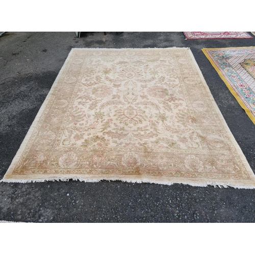 589 - Two large beige Rugs with floral designs, 9ft 8in x 6ft, and 10ft 3in x 7ft 10in